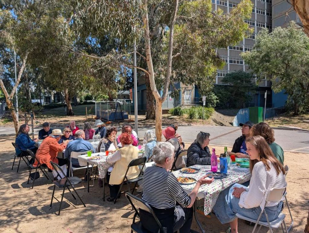 A group of people enjoying the community lunch